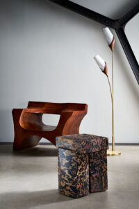José Zanine Caldas wooden armchair, Roberto Sironi marble low table and Joe Armitage floor lamp